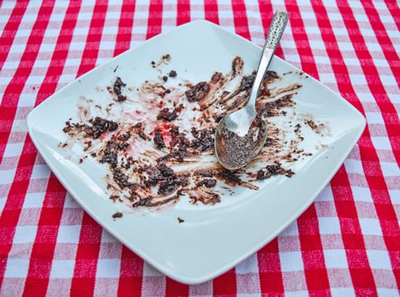 white plate smeared with the remains of a chocolate camping cake