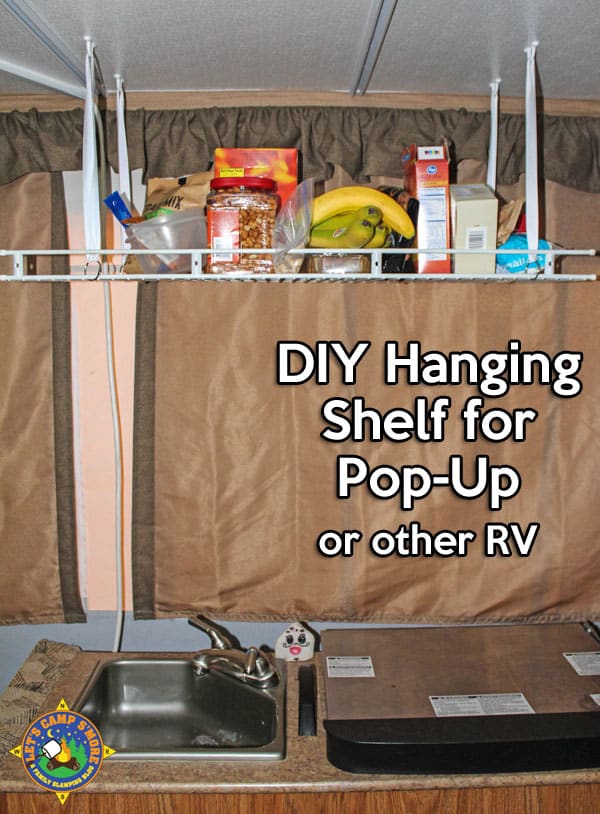 Simple DIY Hanging Shelf Hack for a Pop-Up Camper - Make this simple hanging shelf with an old wire shelf and a few other inexpensive items. It helps you keep the trailer organized. #PopUpCamper #trailer #mod #DIY