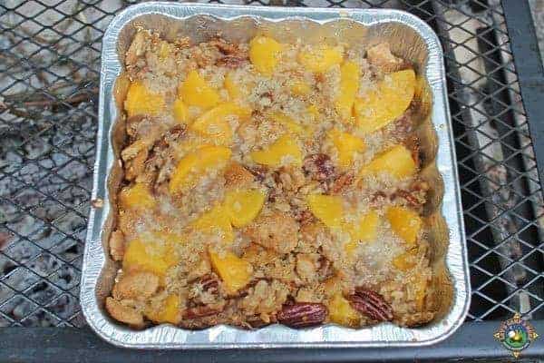 peach crisp in a pan over the campfire