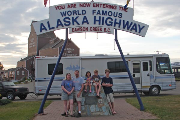 family at the start of the Alaskan highway