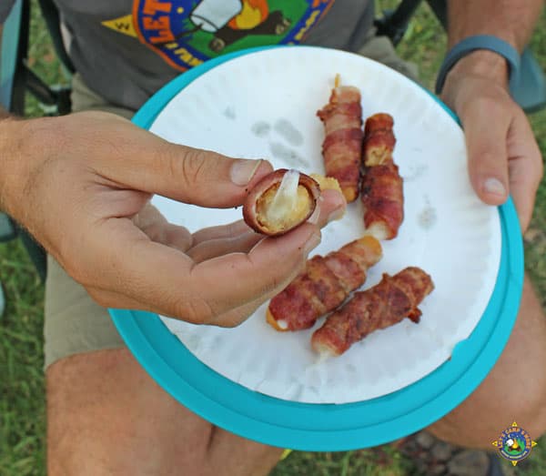 inside of a bacon wrapped mozzarella stick that has been grilled on a campfire