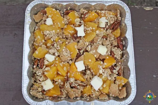 ingredients for campfire peach crisp in a foil pan