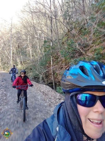 family of 3 riding down a trail