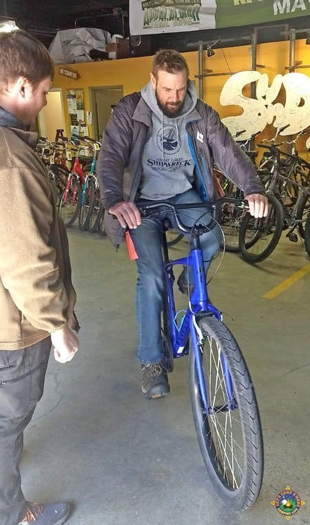 man testing out a rental bicycle