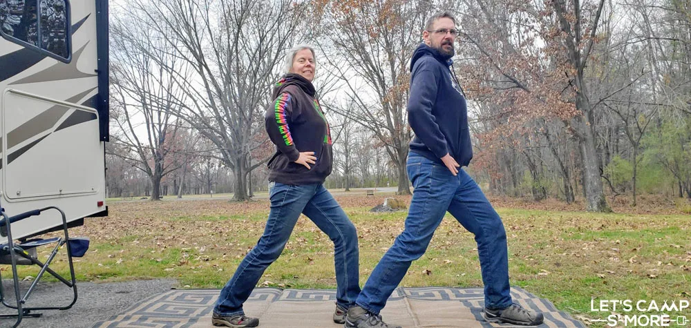 a couple doing lunges for exercise while camping