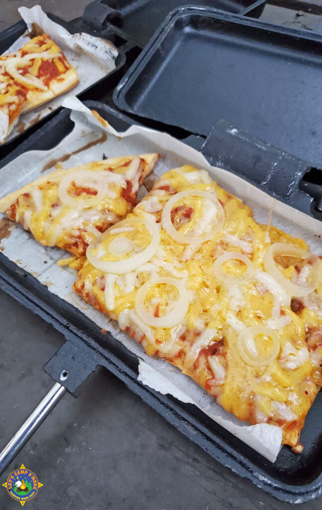 piece of camping pizza with cheese and onions