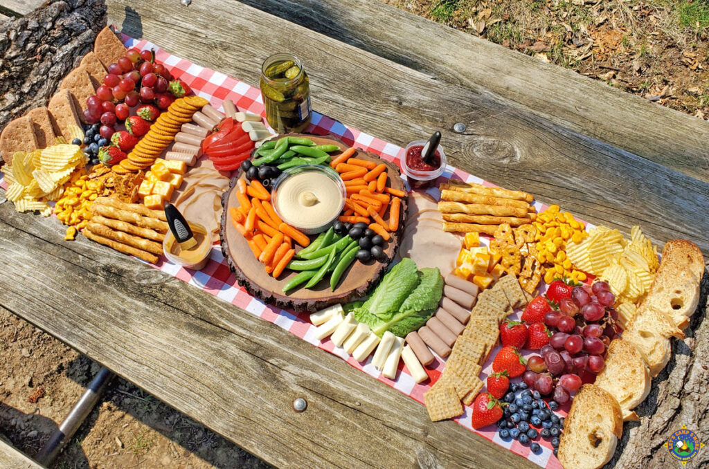 overhead view of a charcuterie board on a picnic table