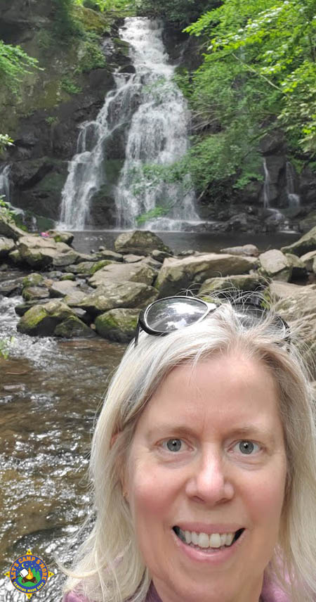 selfie of a woman with a waterfall at Great Smoky Mountain National Park behind her