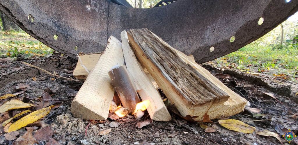 a fire starter log being used to start a campfire