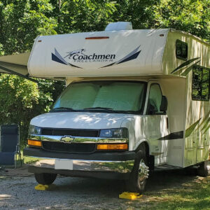 a coachman class c motorhome with the awning open