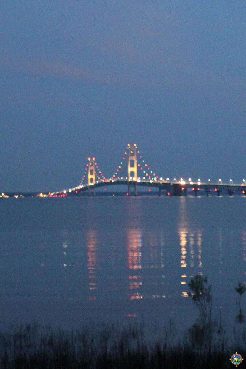 Mackinac Bridge lit up at night as seen from Straights State Park