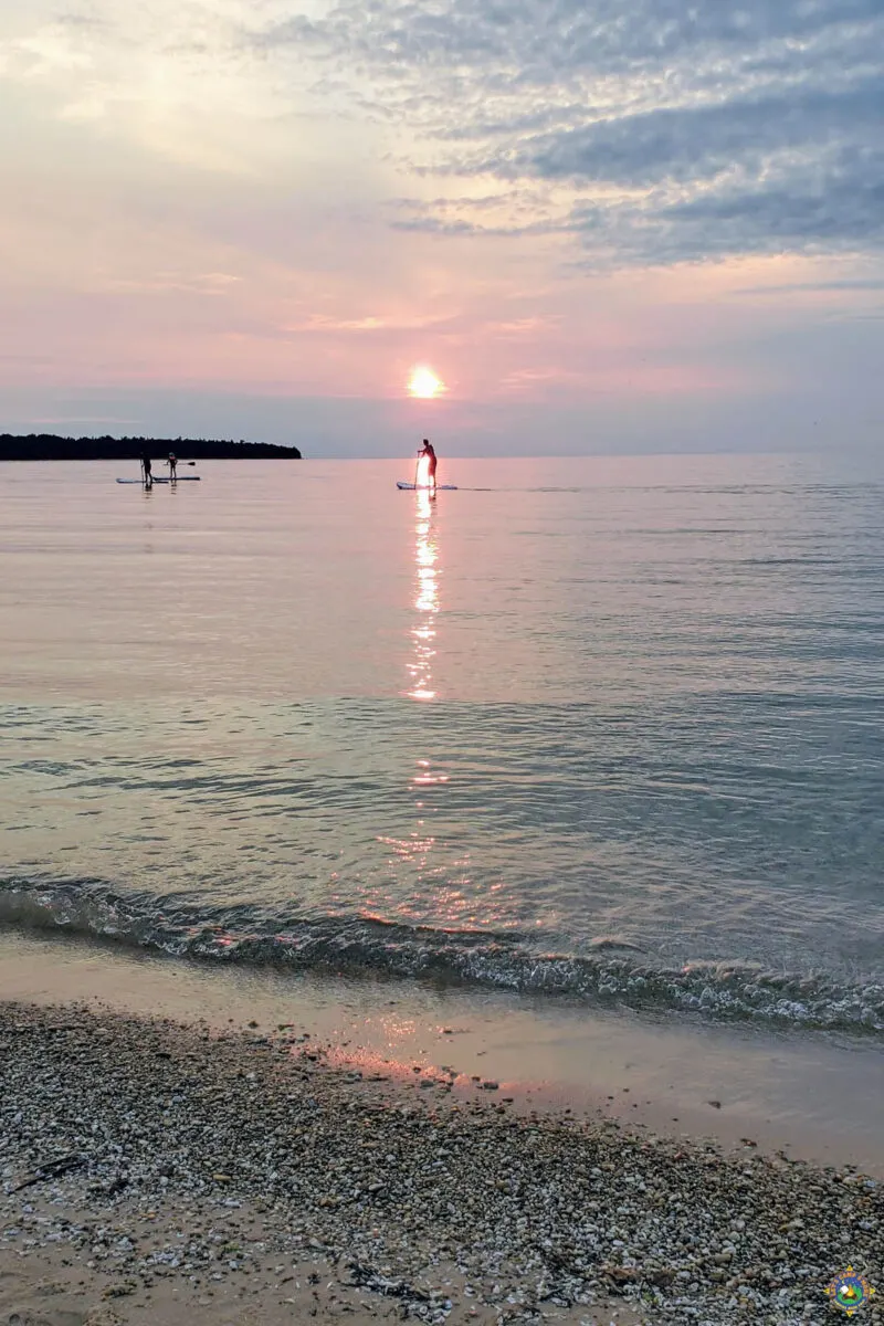 Sun Setting over Lake Michigan with Paddle Boarders silhouetted at Wilderness State Park