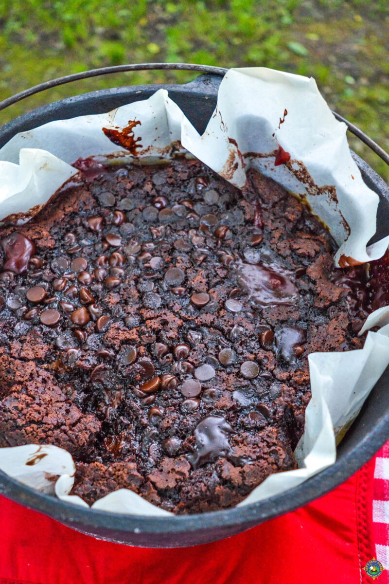 cherry chocolate cake with chocolate chips on top in a dutch oven