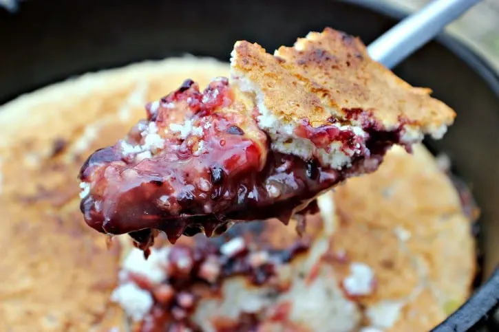 Dutch Oven Blackberry Cobbler with a serving on a spoon