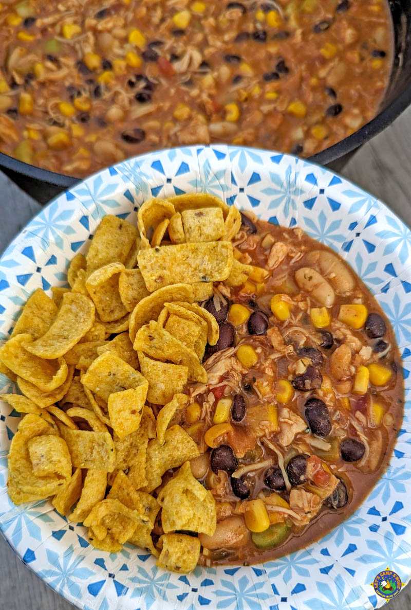 Bowl of Chicken Black Bean Chili with a Dutch Oven pot of chili behind it