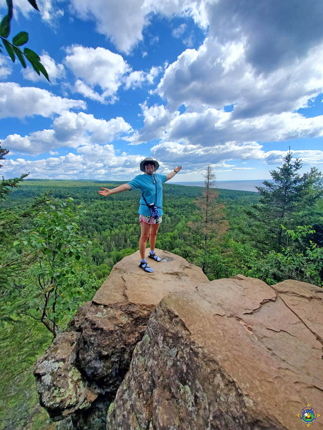 woman on a rock precipice at Lookout Mountain Overlook in Minnesota