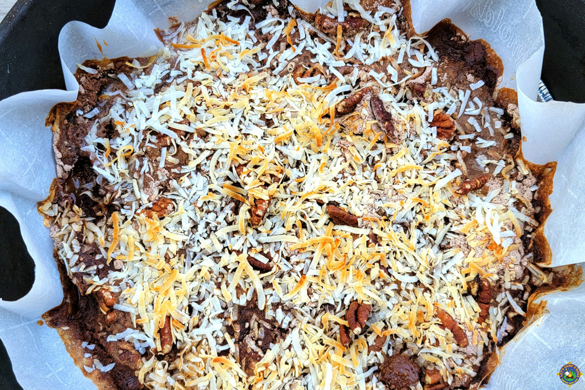 chocolate cake with coconut and pecans in a Dutch oven