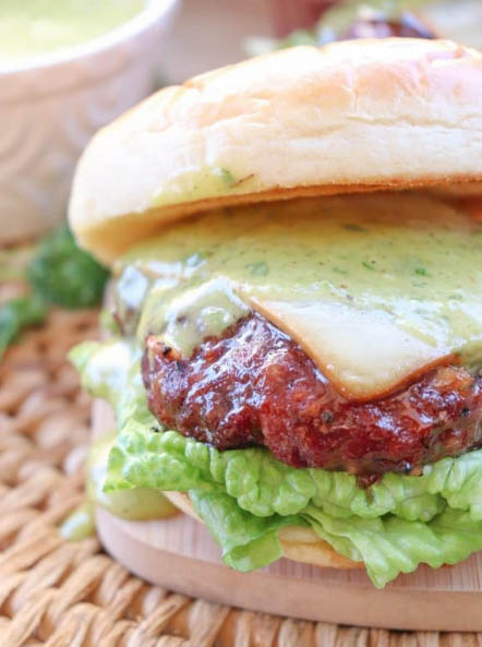 grilled burger with cheese and chimichurri sauce