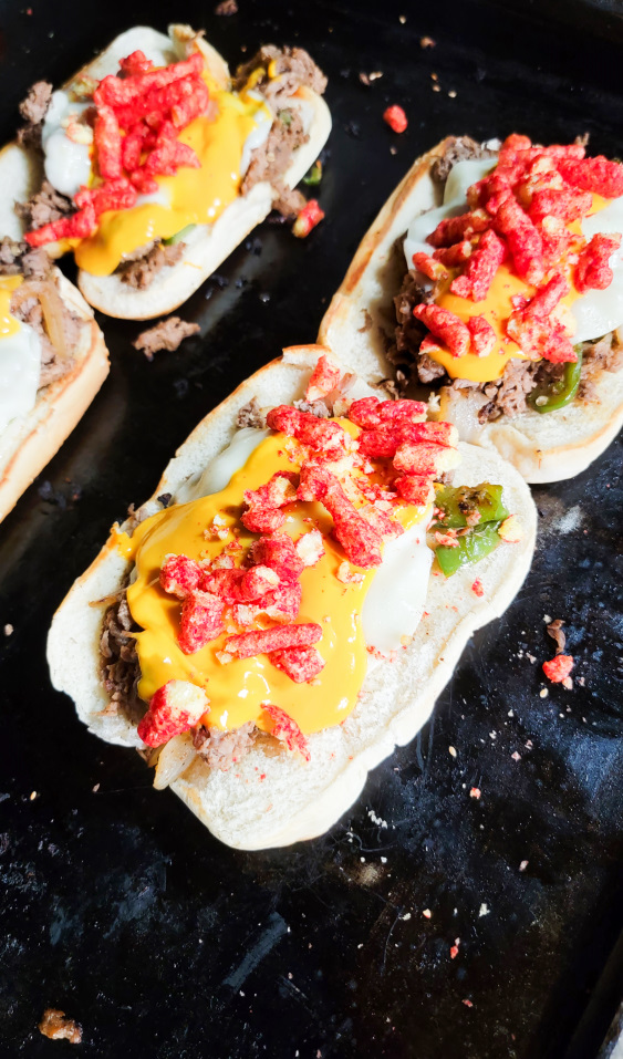 spicy hot cheesesteaks on a griddle