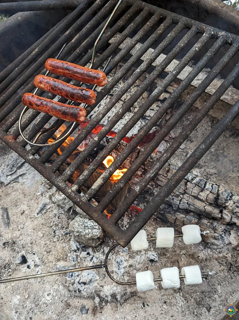 Roasting hot dogs and marshmallows over a campfire