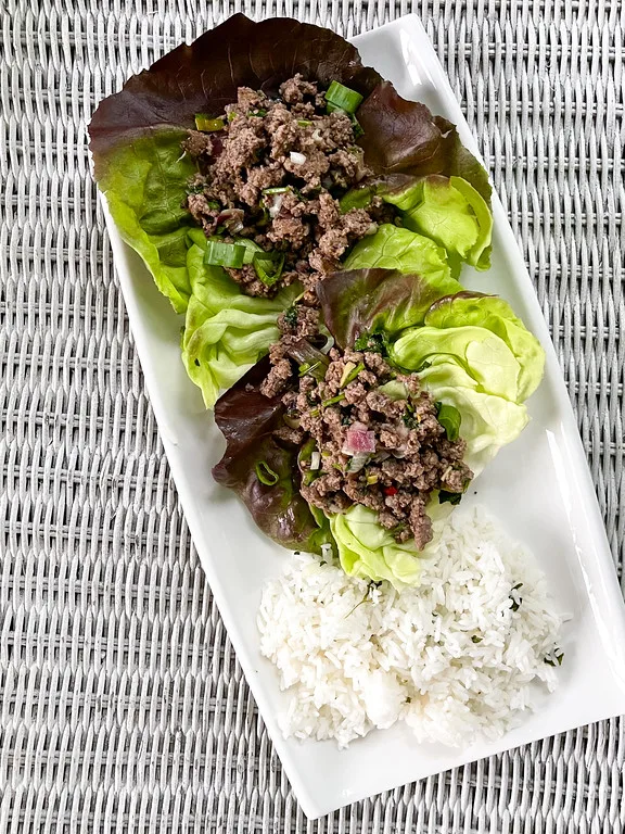 Two Beef Lettuce Wraps with rice on a plate