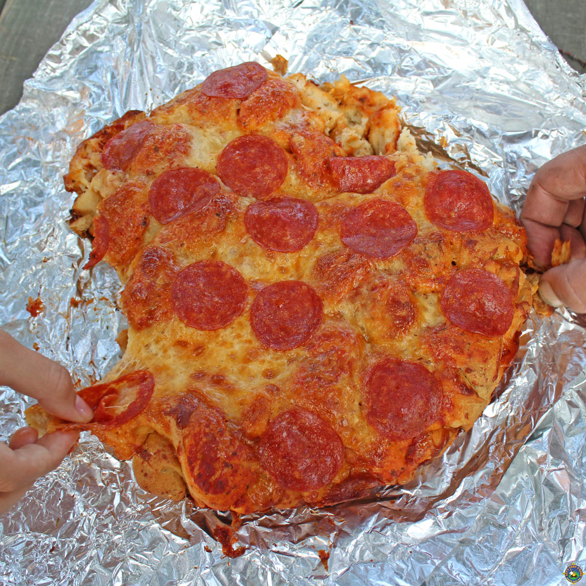 Hands pulling apart Pizza Monkey Bread